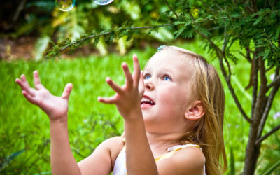 image of little girl popping bubbles