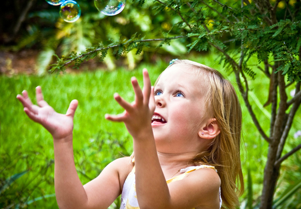 image of little girl popping bubbles