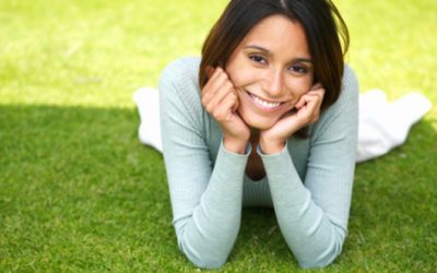 image of smiling woman laying on the grass